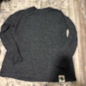Woman’s grey long sleeve top